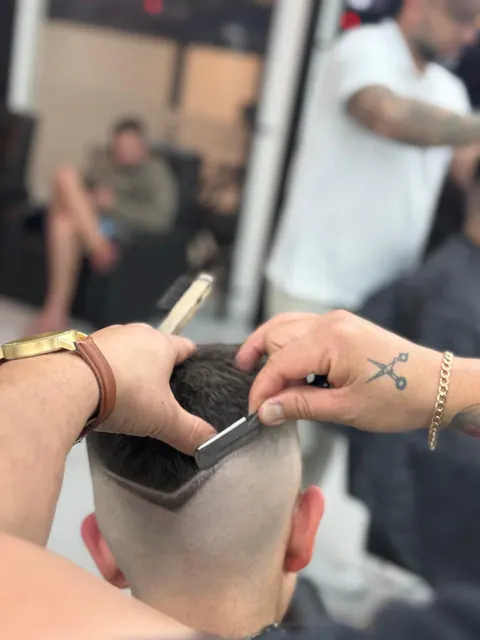 Barbeiro fazendo acabamento e desenho na navalha
